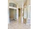 Inviting hallway with neutral colors, tiled flooring, and decorative architectural columns at 2053 E Clubhouse Dr, Phoenix, AZ 85048