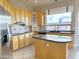 Well-lit kitchen features granite countertops, stainless steel appliances and island at 2053 E Clubhouse Dr, Phoenix, AZ 85048