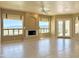 Bright living room with tile flooring, fireplace, ceiling fan and scenic views from large windows at 2053 E Clubhouse Dr, Phoenix, AZ 85048