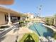 Inviting backyard with a sparkling pool, complemented by tropical landscaping and a spacious patio for outdoor enjoyment at 2053 E Clubhouse Dr, Phoenix, AZ 85048
