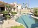 Beautiful backyard with a lagoon style pool, mature landscaping, and desert views at 2053 E Clubhouse Dr, Phoenix, AZ 85048