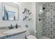 Stylish bathroom with modern fixtures, decorative tile, and a glass-enclosed shower at 2109 W Berridge Ln, Phoenix, AZ 85015