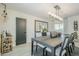 Dining room featuring a modern chandelier, wine rack, and large dining table, adjacent to a full bar at 2109 W Berridge Ln, Phoenix, AZ 85015
