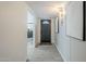 Bright hallway featuring wood-look floors and modern lighting and decor, leading into a space with gray vanity at 2109 W Berridge Ln, Phoenix, AZ 85015