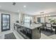 Kitchen island with a gray countertop, sink, dark cabinets, and a view of dining area at 2109 W Berridge Ln, Phoenix, AZ 85015