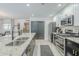 Bright kitchen features stainless steel appliances, an island with a sink, and open layout at 2109 W Berridge Ln, Phoenix, AZ 85015