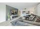 Open living room featuring a modern sectional sofa, entertainment center, and neutral decor at 2109 W Berridge Ln, Phoenix, AZ 85015