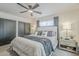Bright main bedroom featuring a ceiling fan, slider closet and comfortable decor at 2109 W Berridge Ln, Phoenix, AZ 85015
