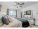 Comfortable main bedroom featuring neutral decor, ceiling fan, and television at 2109 W Berridge Ln, Phoenix, AZ 85015