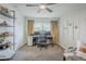 Bright office with a ceiling fan, modern desk setup, and comfortable seating area at 2109 W Berridge Ln, Phoenix, AZ 85015