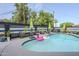 Inviting backyard pool with lounge chairs, umbrellas, and playful flamingo and unicorn floats at 2109 W Berridge Ln, Phoenix, AZ 85015