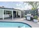 Backyard patio featuring a built-in grill, dining area, and poolside lounge at 2109 W Berridge Ln, Phoenix, AZ 85015