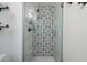 Modern shower featuring decorative tile and glass door at 2109 W Berridge Ln, Phoenix, AZ 85015