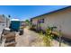 Side yard featuring a small shed, dirt, fencing, and mature plants under a clear sky at 2129 N Summer St, Mesa, AZ 85203