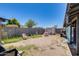 Backyard area featuring a shed, mature tree, block wall, and partial patio cover at 2129 N Summer St, Mesa, AZ 85203