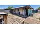Exterior shot showcasing the backyard, partially covered patio, and building materials at 2129 N Summer St, Mesa, AZ 85203