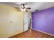 Bedroom with unique two-tone walls, a ceiling fan, a closet, and vinyl flooring at 2129 N Summer St, Mesa, AZ 85203