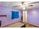 Bedroom with purple walls featuring a ceiling fan and closet at 2129 N Summer St, Mesa, AZ 85203
