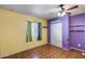 Bedroom featuring multi-toned walls, vinyl flooring, a window, and a ceiling fan at 2129 N Summer St, Mesa, AZ 85203