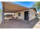 Quaint single-story home featuring a covered carport leading to the main entrance with a secure gate at 2129 N Summer St, Mesa, AZ 85203