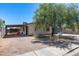 Quaint single-story home featuring a large tree, carport, and easy-to-maintain desert landscaping at 2129 N Summer St, Mesa, AZ 85203