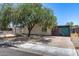 Quaint single-story home featuring a large tree, and easy-to-maintain desert landscaping at 2129 N Summer St, Mesa, AZ 85203