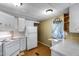 Bright kitchen featuring white appliances, white cabinets, and classic design at 2129 N Summer St, Mesa, AZ 85203