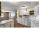 Functional kitchen with white cabinets, classic appliances, and tiled countertops offer a practical design at 2129 N Summer St, Mesa, AZ 85203