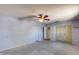 Living area with gray walls, concrete floors, fan, and closet with door visible at 2129 N Summer St, Mesa, AZ 85203
