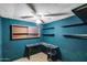 Home office with blue paneling, built in shelving, and a ceiling fan at 2129 N Summer St, Mesa, AZ 85203