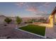 Well-manicured backyard featuring vibrant artificial turf and desert landscaping providing a serene outdoor retreat at 2236 W Aston Dr, San Tan Valley, AZ 85144