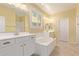 Luxurious bathroom features dual sinks, soaking tub, and white cabinetry at 2236 W Aston Dr, San Tan Valley, AZ 85144