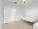 A simple bedroom with tile floors, neutral walls, and ceiling fan at 2236 W Aston Dr, San Tan Valley, AZ 85144
