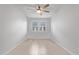 A minimalist bedroom design featuring tile flooring, ceiling fan, and two windows at 2236 W Aston Dr, San Tan Valley, AZ 85144