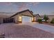 Beautiful home with a brick paved driveway and a pristine two-car garage with a manicured lawn at 2236 W Aston Dr, San Tan Valley, AZ 85144