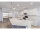 Modern kitchen featuring a large island, stainless steel appliances, and bright, white cabinets at 2236 W Aston Dr, San Tan Valley, AZ 85144