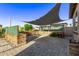 Charming brick-paved patio featuring a custom pergola offering shade for outdoor relaxation and entertainment at 2236 W Aston Dr, San Tan Valley, AZ 85144