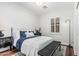 This bedroom has white walls, dark floors, and a window with shutters at 2542 E Los Alamos St, Gilbert, AZ 85295