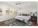 Light-filled bedroom features a neutral color palette, shutters, and modern ceiling fan at 2542 E Los Alamos St, Gilbert, AZ 85295