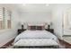 Bedroom with hardwood floors and white walls filled with natural light from a window with shutters at 2542 E Los Alamos St, Gilbert, AZ 85295