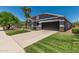 Charming home with manicured lawn, stone accents, and attached two car garage at 2542 E Los Alamos St, Gilbert, AZ 85295