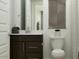Bathroom with a toilet, vanity, and a decorative modern wall hanging at 3122 S 156Th Ave, Goodyear, AZ 85338