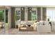 Bright living room features a cozy seating area with a sofa, rug, and natural light through large windows at 3122 S 156Th Ave, Goodyear, AZ 85338