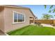 This home features a private backyard with a covered patio and well-maintained artificial grass at 3123 S 155Th Ln, Goodyear, AZ 85338