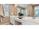 Bathroom featuring a large mirror, dual sinks, and white cabinets at 3123 S 155Th Ln, Goodyear, AZ 85338