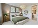 Bedroom featuring earth tone walls, decorative lighting and ensuite bathroom at 3123 S 155Th Ln, Goodyear, AZ 85338