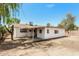 Spacious backyard with covered patio and mature trees offering ample outdoor living space at 3238 W Rose Ln, Phoenix, AZ 85017