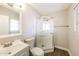 A modern bathroom with a glass shower, updated vanity, and wood look floors at 3238 W Rose Ln, Phoenix, AZ 85017
