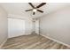 This bedroom includes a ceiling fan, closet, laminate flooring, and neutral paint at 3238 W Rose Ln, Phoenix, AZ 85017