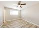 An empty bedroom featuring a ceiling fan, light colored walls and laminate wood flooring at 3238 W Rose Ln, Phoenix, AZ 85017